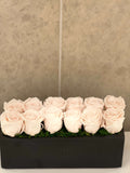 TWELVE PRESERVED ROSES IN RECTANGULAR VASE